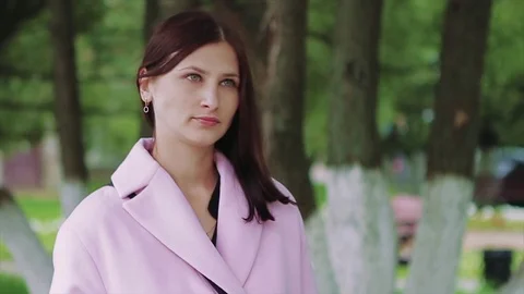 Pensive Look of a Young Dark-Haired Girl in Park Stock Footage 72086720