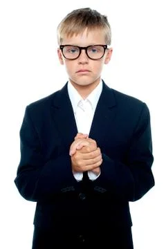 Pensive looking boy posing with hands clasped Stock Photos