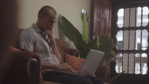 Pensive male freelancer using laptop indoors Stock Footage 341892622