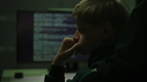 Pensive male hacker or programmer deep in thought, brainstorming solutions while Stock Footage 321685606