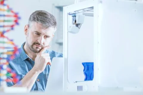 Pensive man and 3d printer Stock Photos