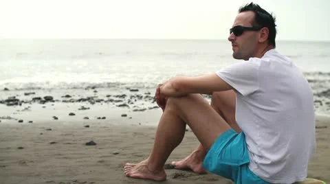 Pensive man on beach looking at the sea HD Stock Footage 10851222