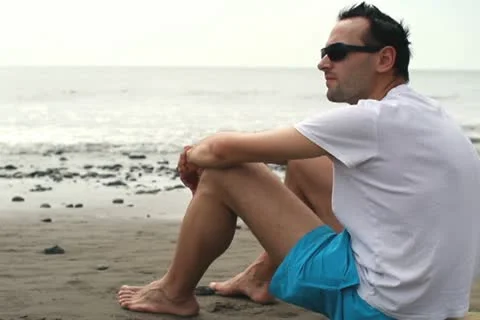 Pensive man on beach looking at the sea NTSC Stock Footage 10851233