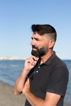 Pensive man on a beach. Stock Photos