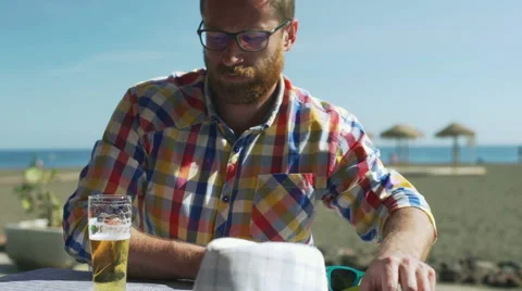 Pensive man drinking beer in the cafe and having problems Stock Footage 60133679