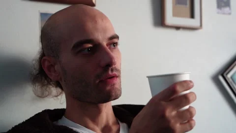 Pensive man drinking coffee in a cafe close-up Video stock 224332117