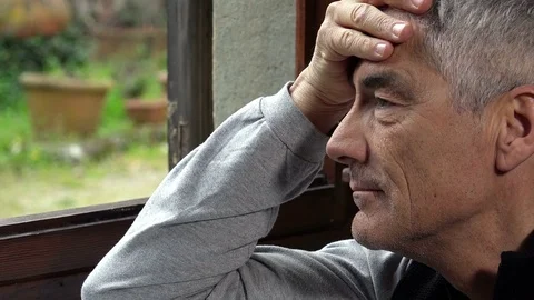 Pensive man face at the window 스톡 동영상 74684413