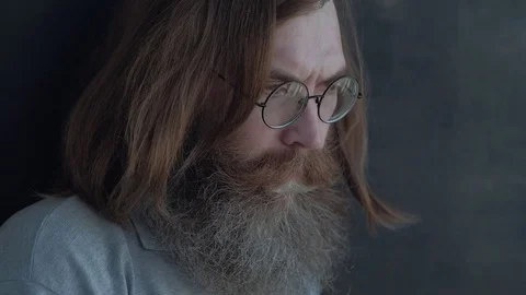 Pensive Man With Glasses Standing at the Window Thinking About Something Stock Footage 77026132