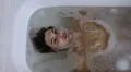 a pensive man is immersed / diving in the bath tub - apnoea - washing bathtube HD Footage