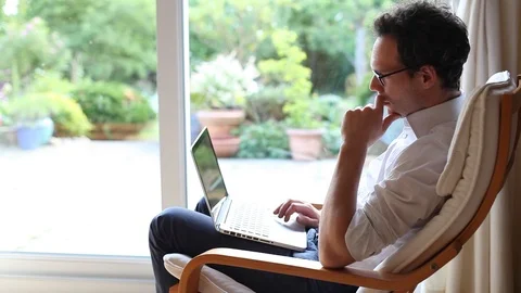 Pensive man looking at computer and thinking Video stock 98093545