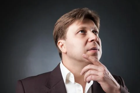 Pensive man looking up Stock Photos