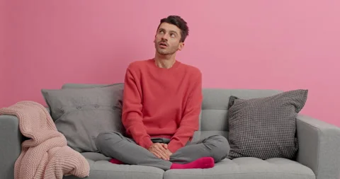 Pensive man looks thoughtfully around thinks about interior for his new Stock Footage 143633167