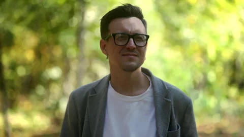 Pensive Man in Nature Experiencing Reflective Moments Amidst a Serene Green Stock Footage 288435812