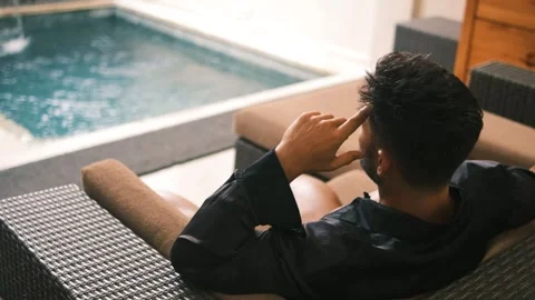 Pensive Man Sitting on Couch – Confused and Deep in Thought Stock Footage 275925515