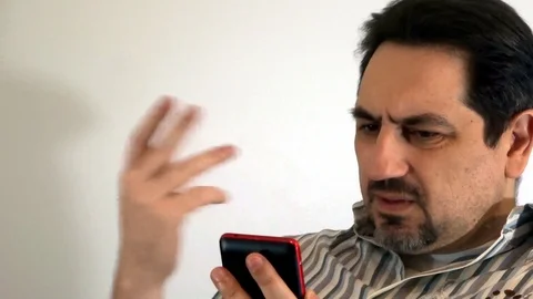 Pensive man with a smartphone Stock Footage 93099297