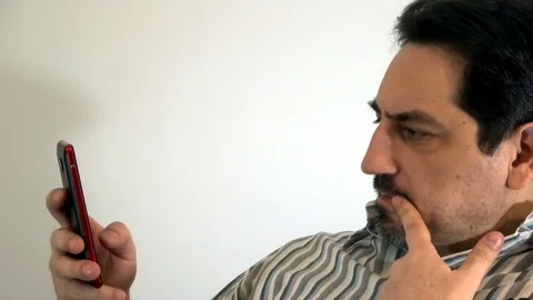 Pensive man with a smartphone Stock Footage 93099353