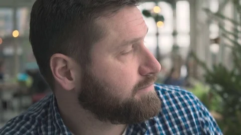 Pensive man smile to camera, portrait, in cafe, very close steadicam shot Vidéo 72952186
