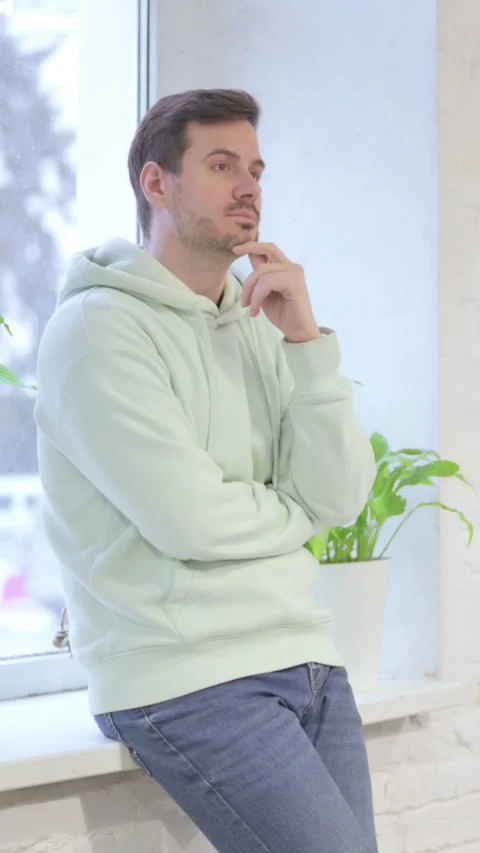 Pensive Man Thinking while Standing Near Window, vertical video 스톡 동영상 329105221