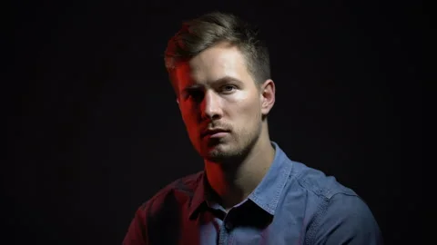Pensive man under dark-red and white light, split personality, psychology Stock Footage 105042859
