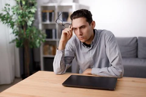 Pensive man using laptop Foto stock