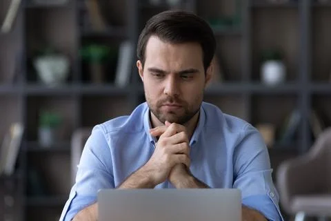 Pensive man work on laptop thinking of problem Foto stock