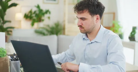 Pensive Man Working Remotely on Laptop Stock Footage 275824201