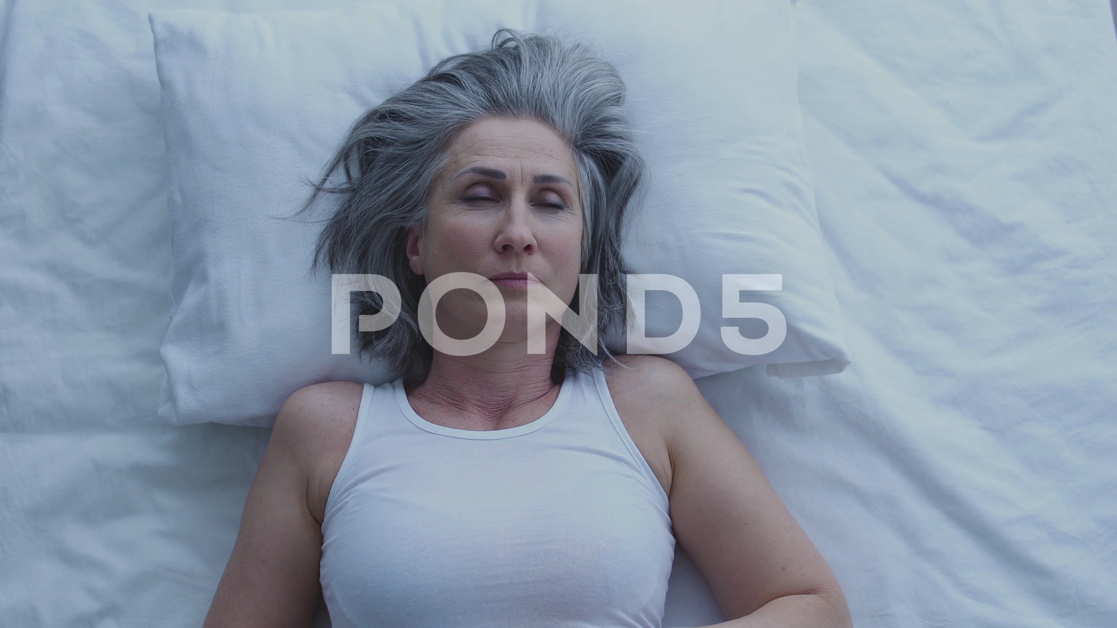 Pensive mature woman lying in bed, thinking about problem, difficult  decision