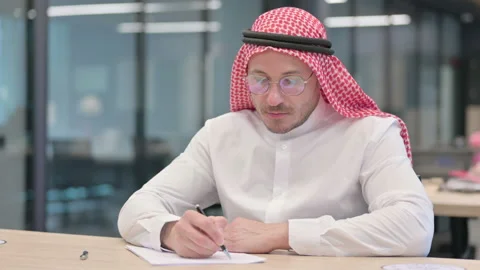 Pensive Middle Aged Arab Man Writing on Paper Stock Footage 152523890