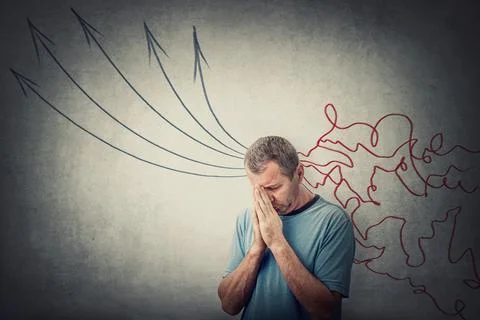 Pensive middle aged man, keeps hands as prayer trying to set and focus his mi Stock Photos