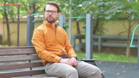 Pensive Middle Aged Man Sitting Outdoor Video stock 282430760