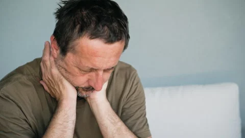 Pensive middle-aged man sitting on sofa deep in thought looking worried and.. Stock Footage 341662167