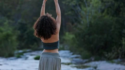 A Pensive Moment by the Stream: Capturing the Introspection of a Woman in Stock Footage 318412859
