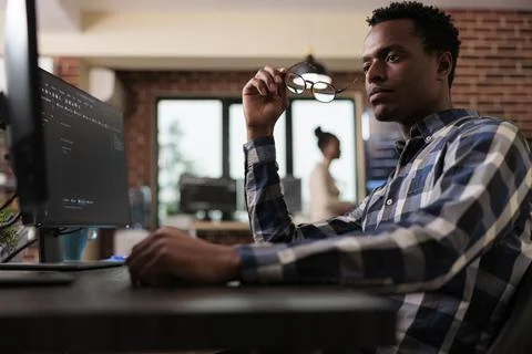 Pensive network engineer reflecting at failed data processing operation 写真素材