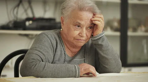 Pensive old lady sit in her kitchen Stock Footage 67521872