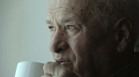 Pensive old man drinking a cup of coffee or tea Stock Footage 48058578