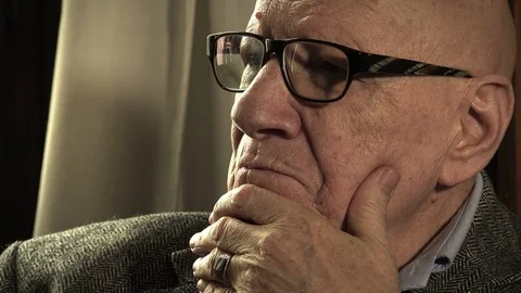 Pensive old man sitting alone deep in his depression and problems Stock Footage