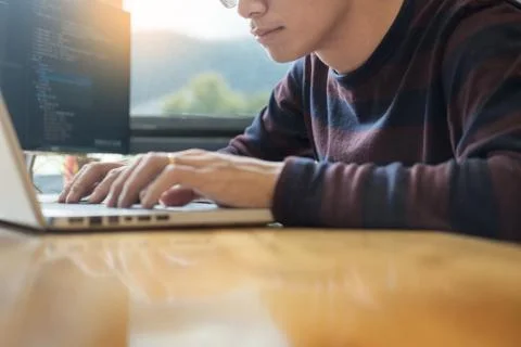 Pensive programmer working on on desktop pc programming code technologies or 写真素材