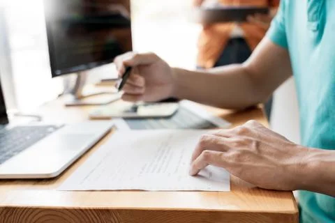 Pensive programmer working on on desktop pc programming code technologies or Foto stock