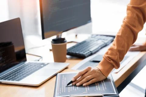 Pensive programmer working on on desktop pc programming code technologies or 写真素材