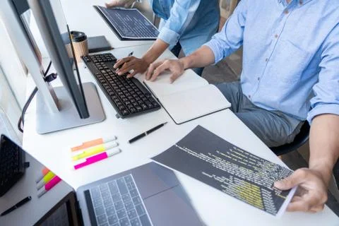 Pensive programmer working on on desktop pc programming code technologies or 스톡 사진