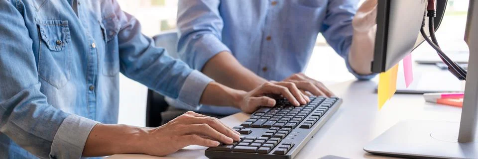 Pensive programmer working on on desktop pc programming code technologies or 库存照片