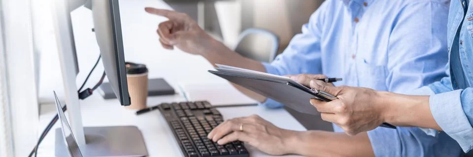 Pensive programmer working on on desktop pc programming code technologies or 库存照片