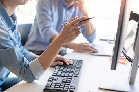 Pensive programmer working on on desktop pc programming code technologies or 스톡 사진