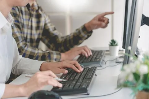 Pensive programmer working on desktop pc programming code technologies or web 库存照片