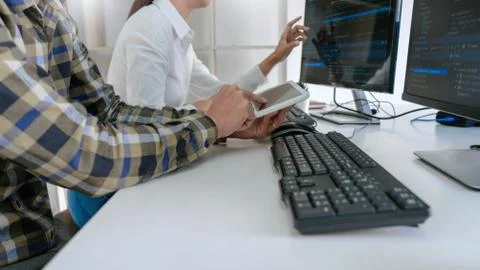 Pensive programmer working on desktop pc programming code technologies or web Stockfoto's