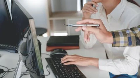 Pensive programmer working on desktop pc programming code technologies or web Stock Photos