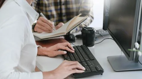 Pensive programmer working on desktop pc programming code technologies or web Foto stock