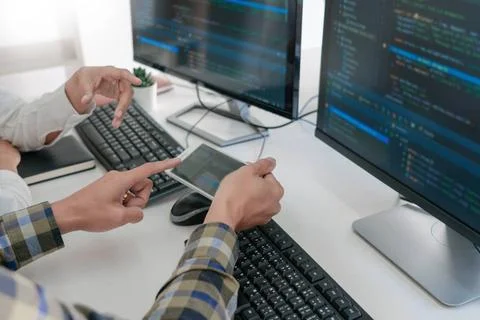 Pensive programmer working on desktop pc programming code technologies or ... 스톡 사진