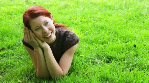 Pensive redhaired girl on meadow Stock Footage 7737140