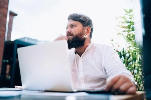 Pensive remote worker using laptop and thinking on problem Stock Photos